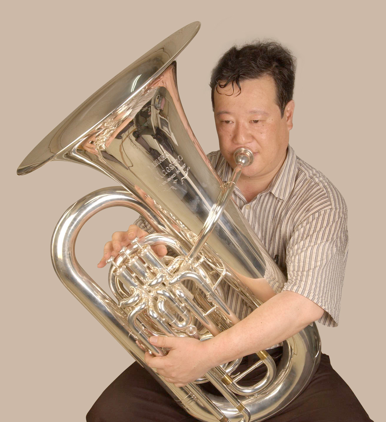 Top-action tubas have the bell on the player's right side