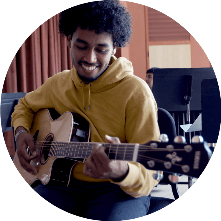 image of a man playing yamaha guitar