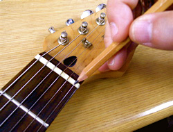 Maintaining the fingerboard and frets.