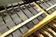A row of sound bars beneath resonator boxes