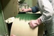 The first stage of painting, a special coat of dark green is applied.