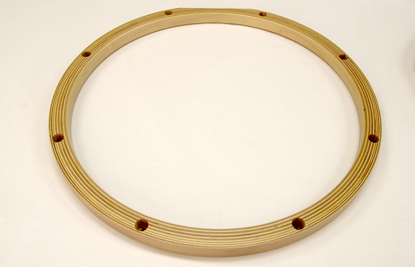 The 19-ply wooden hoop, with holes to recess the tuning-bolt