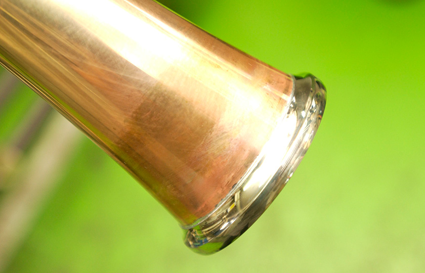 A silver-colored screw on the bell stem