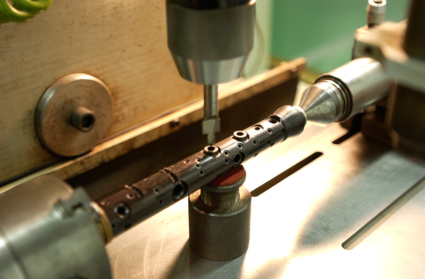Opening tone holes using a rotary cutter.