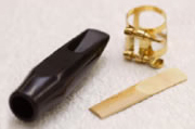 The black part is the mouthpiece, the metal part is the ligature, and wooden part is the reed