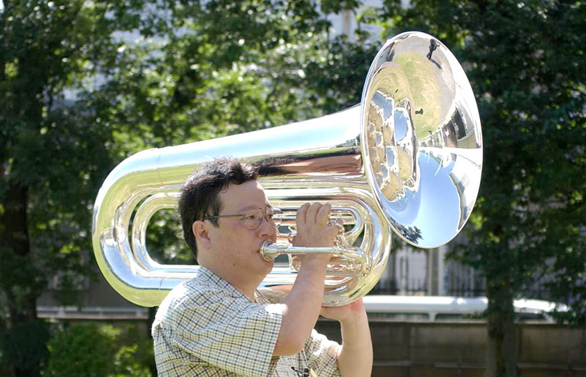 A marching tuba propped up on the player's shoulder