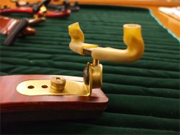 The foot of a bridge-type shoulder rest. Use the screws to adjust the spacing and height of the feet
