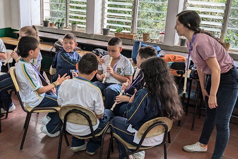 [Image] Colombian children listening to each other’s performances during group work