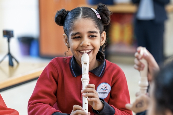 [Image] An Egyptian child playing the recorder with a smile