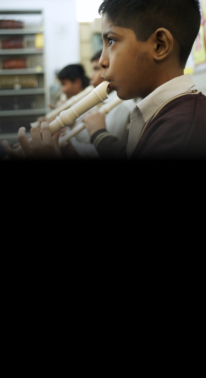 [Image] An Indian boy playing the recorder seriously