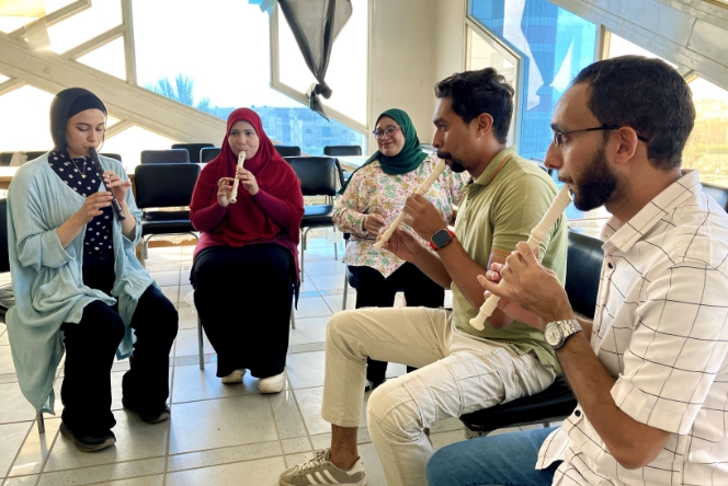[Image] Egyptian teachers playing the recorder during a teacher training.