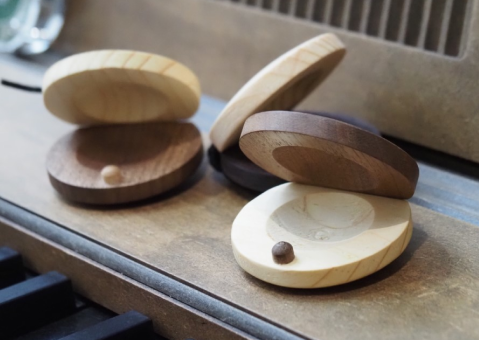 Handmade castanets created from unused wood generated during the production of pianos, guitars, marimbas, and other instruments.