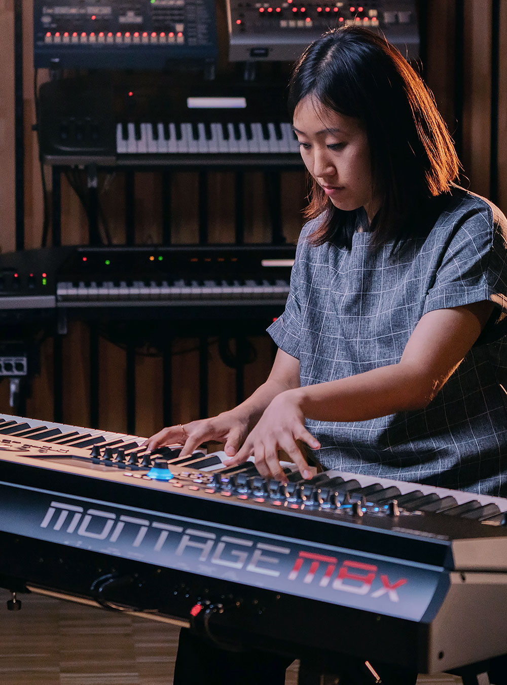 Young woman playing the E.S.P. for MONTAGE M SYNTHESIZERS