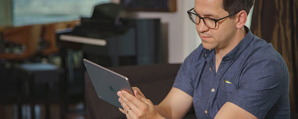 guy holding and browsing an ipad