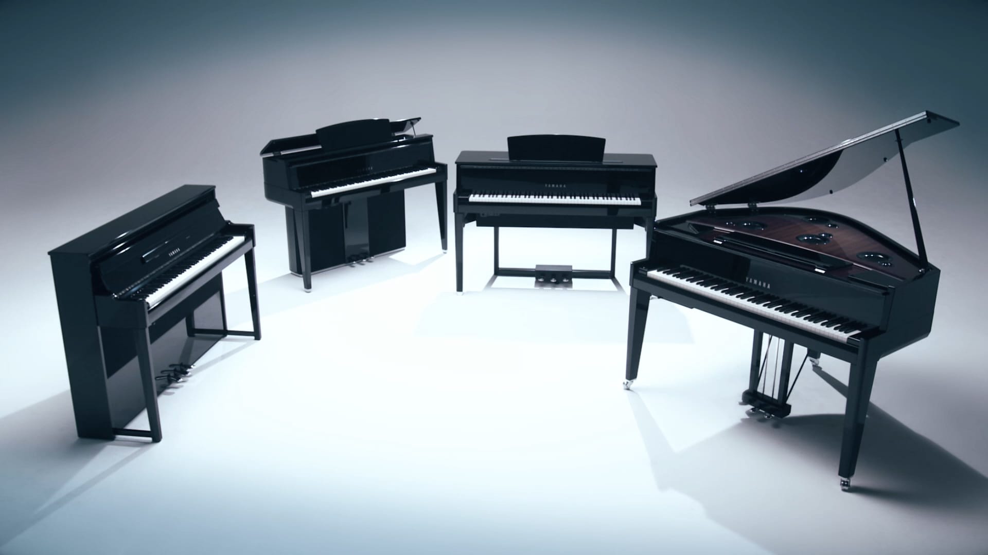 four models of avangrand piano in a gradient grey background 