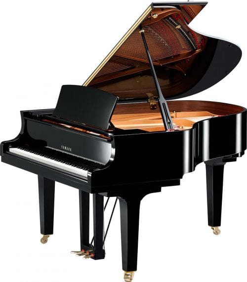 Yamaha baby grand piano with lid open viewed from right side.