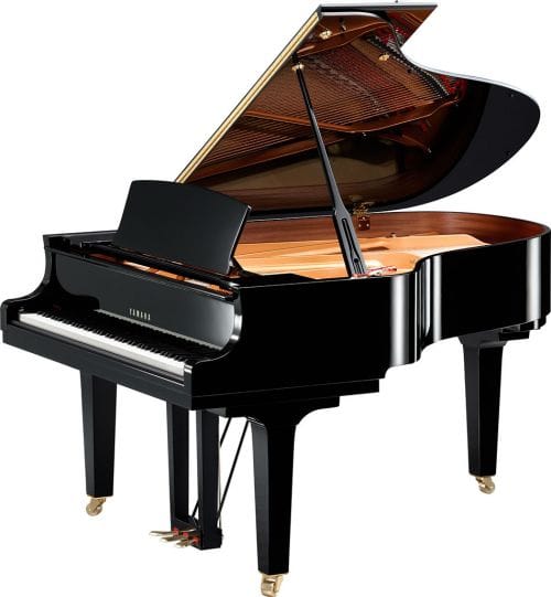 Yamaha baby grand piano with lid open viewed from right side.