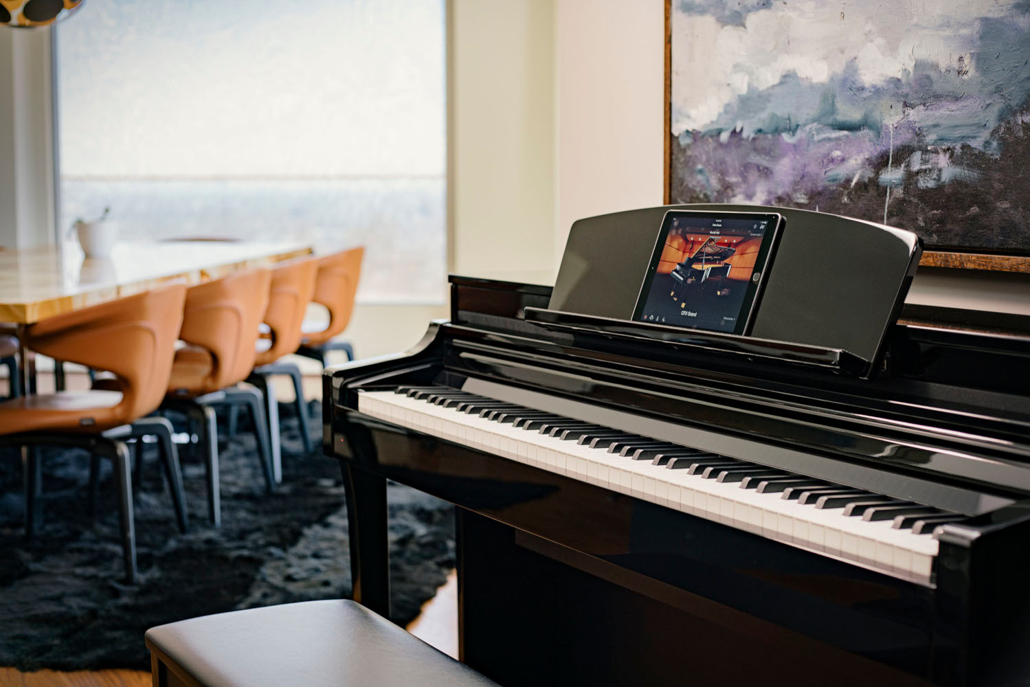 Clavinova piano in a room with table and chairs 