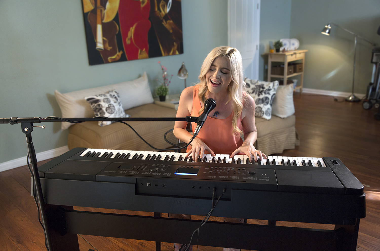 Image showing a female singing while playing digital piano