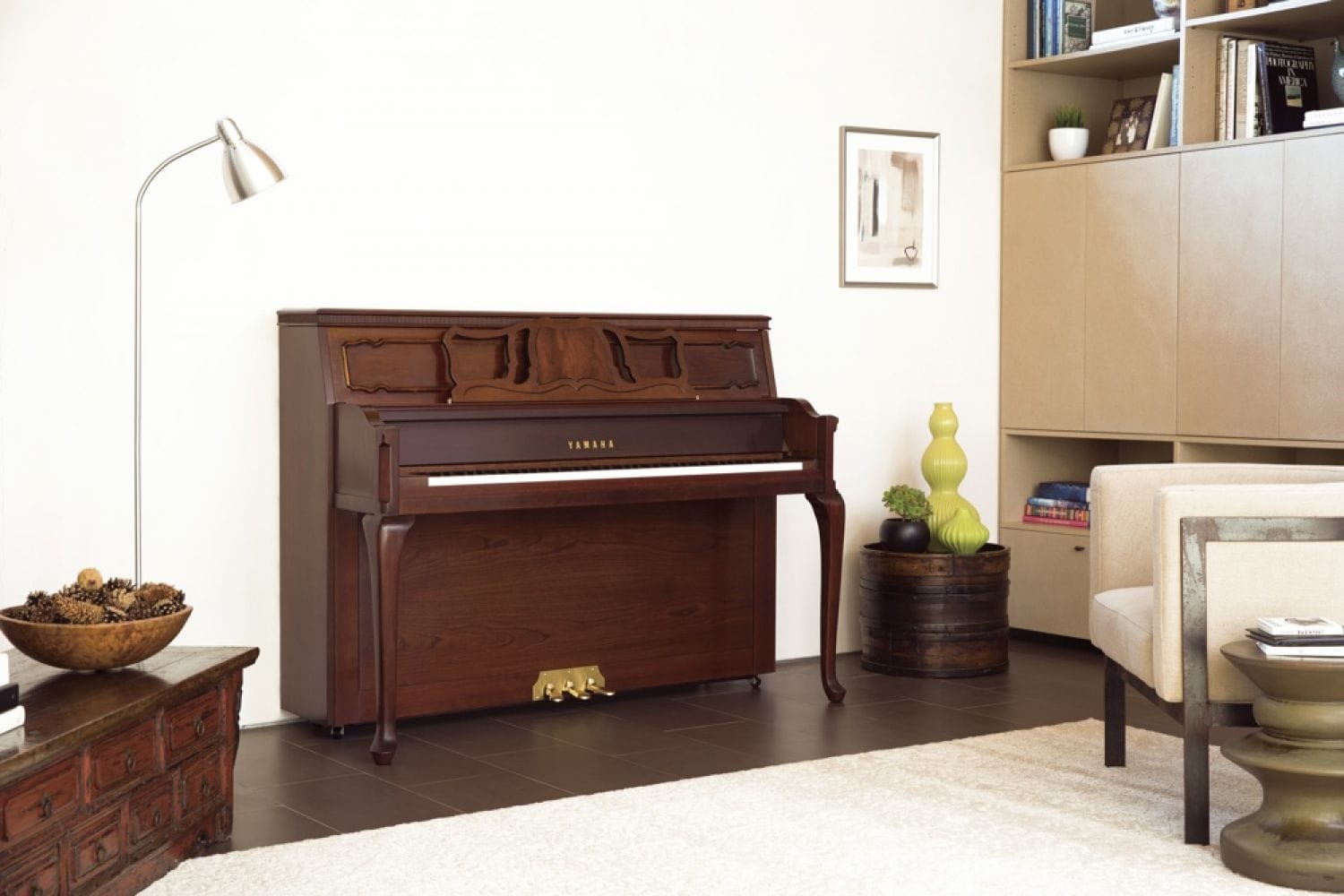 A Yamaha upright with a traditional feel with Queen Anne legs in an eclectically designed living space.