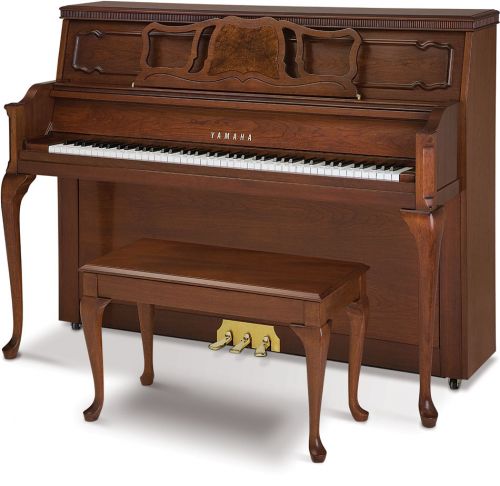 Upright Yamaha piano and matching bench in walnut tones and with traditional touches such as Queen Anne legs and trim.