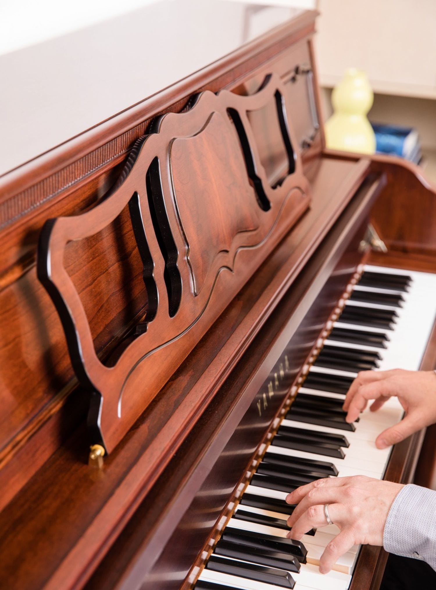 An adult male's hands playing the piano.