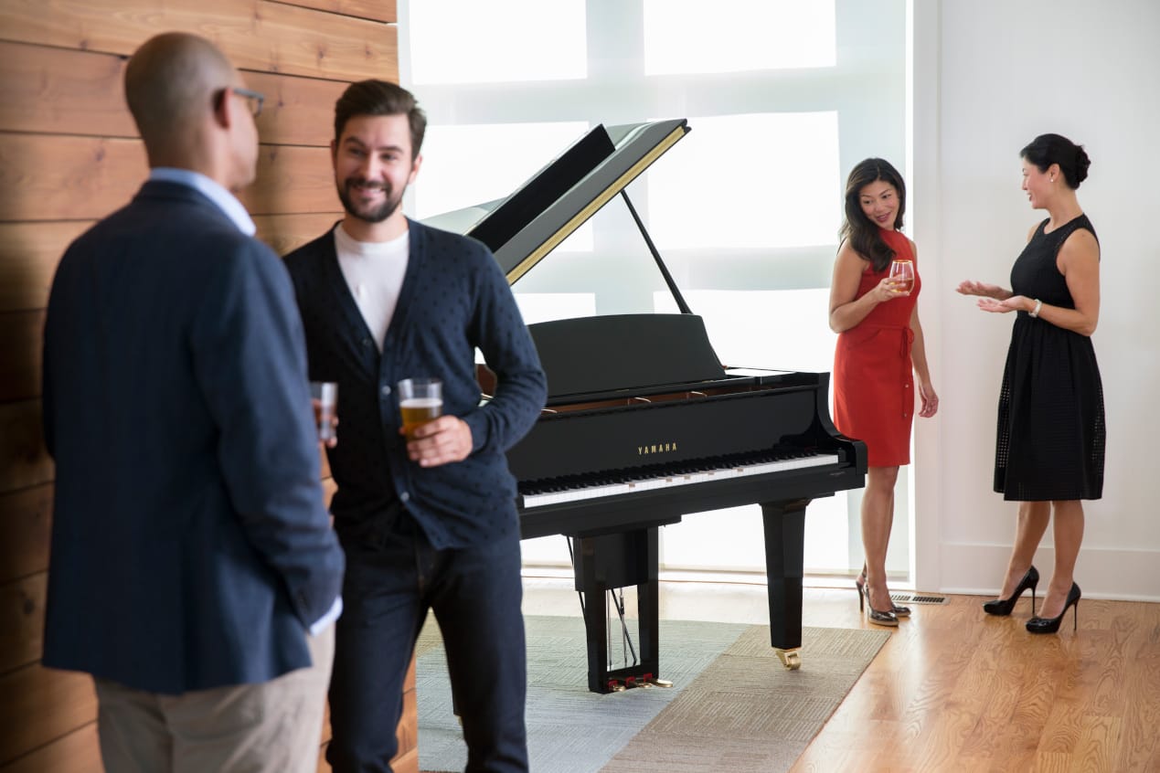 image of peoples standing beside yamaha disklavier piano