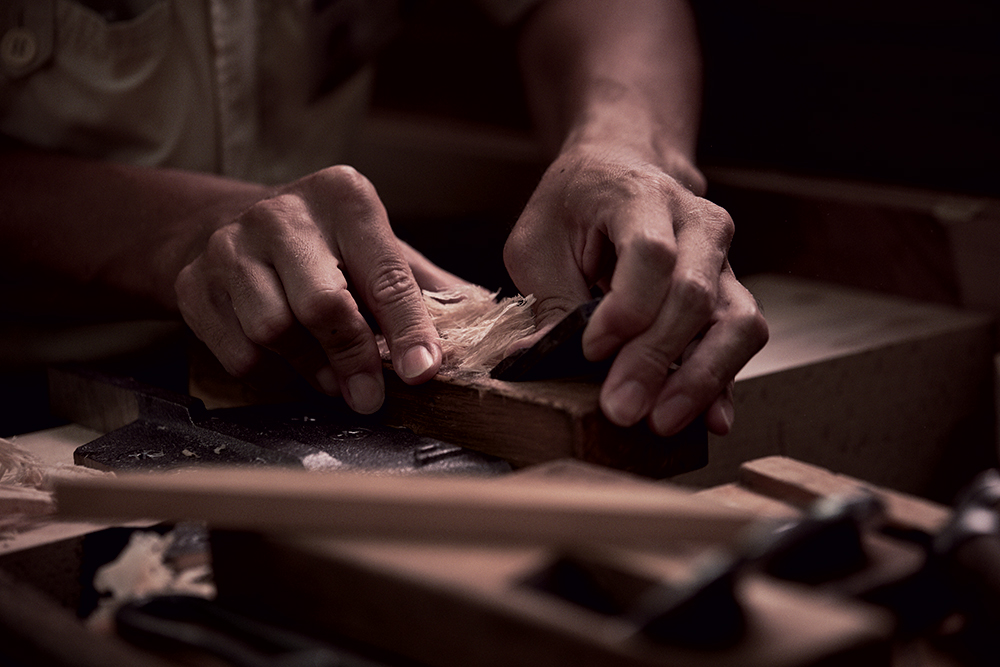 two hands doing woodwork