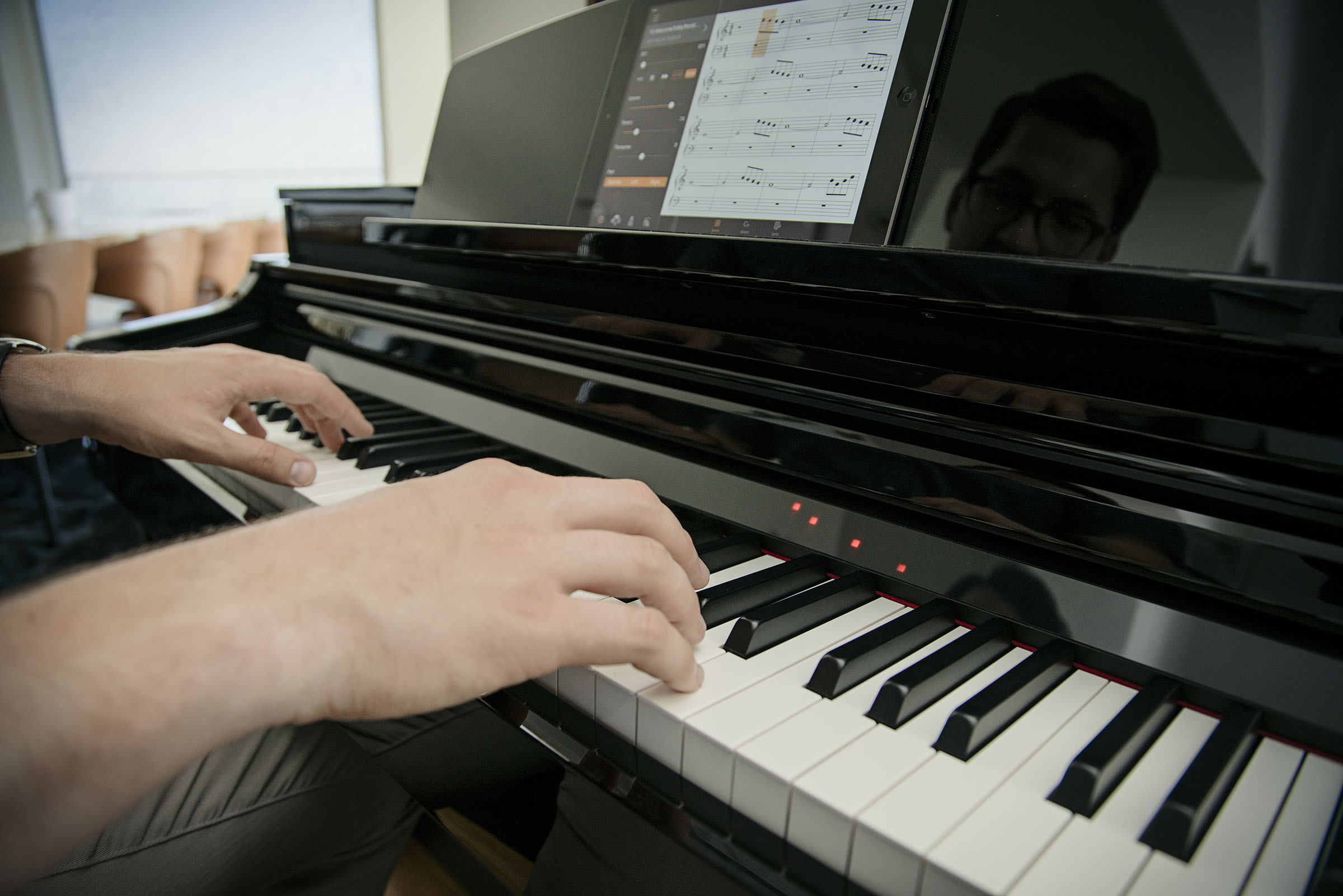 two hands playing the clavinova piano