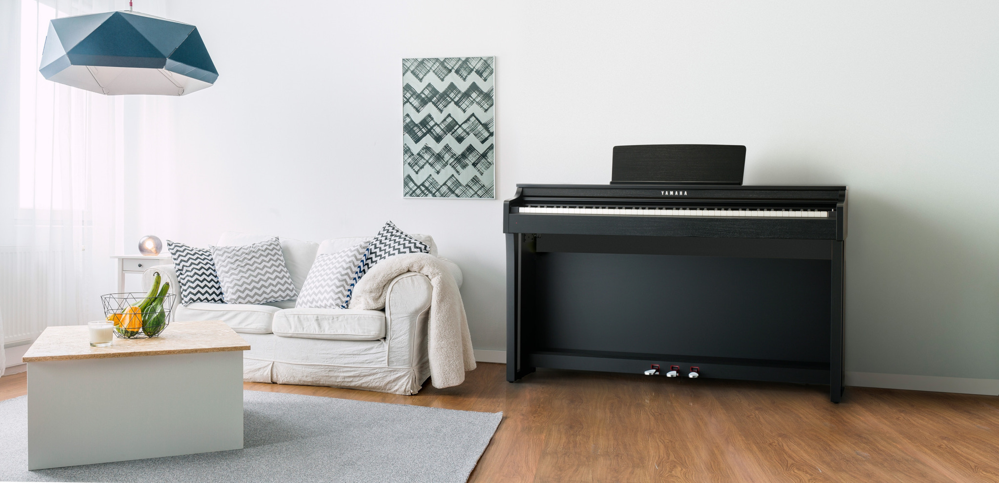 black clp piano in a white wall of a nice and cozy livingroom 