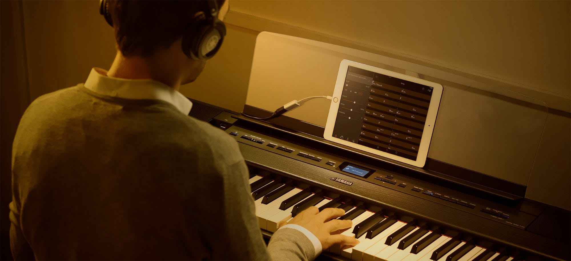 man playing Yamaha digital piano