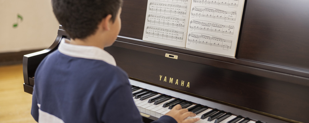 Young kid playing a piano.