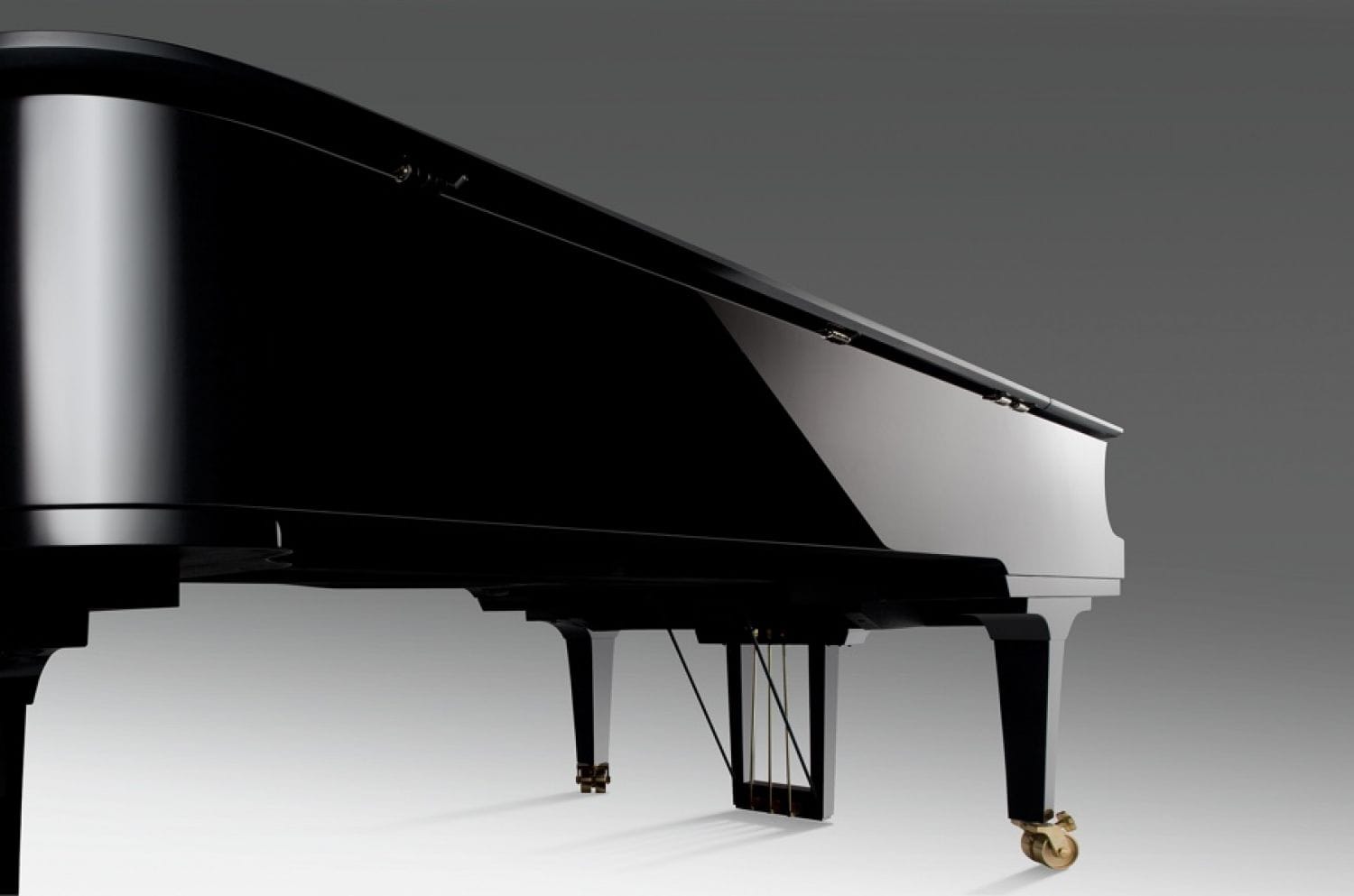 A view of the left side of a piano with a focus on the highly polished finish.