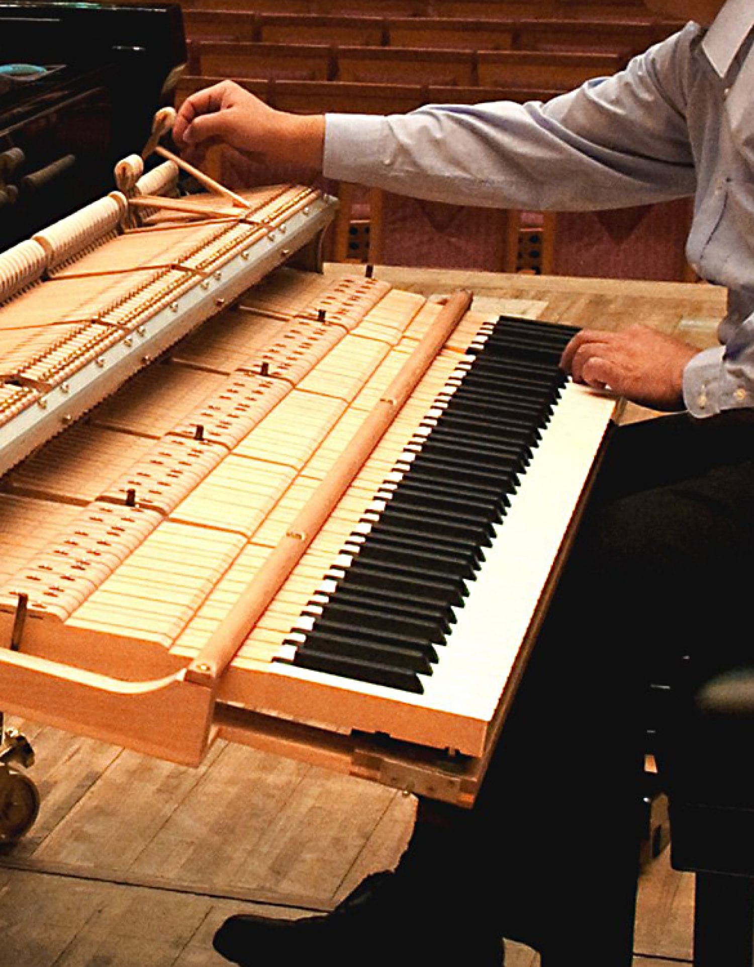 Technician testing hammers as he hits keys.