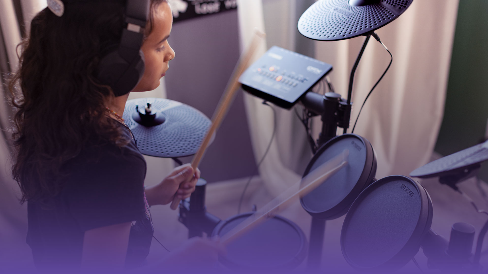 a girl playing yamaha dtx drum