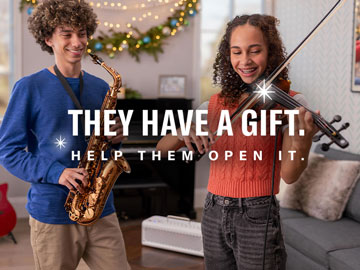 image of two young girls playing yamaha violin and yamaha trumpet respectively