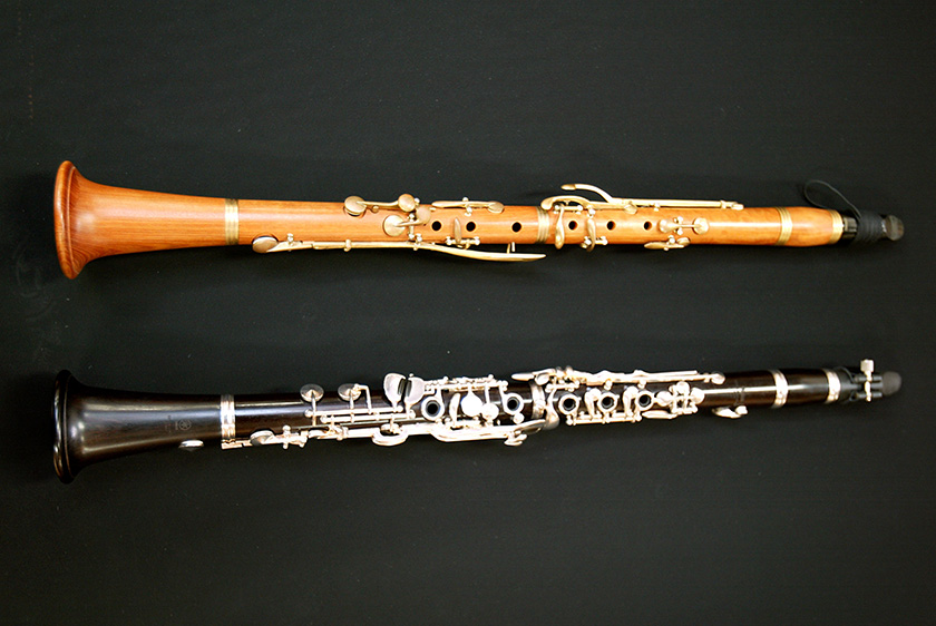 An old-time boxwood clarinet (top) and a modern-day grenadilla clarinet (bottom)
